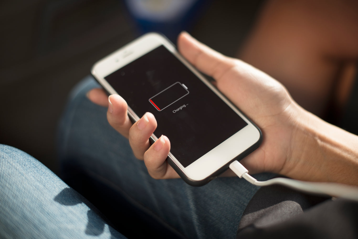 woman charging a dead iphone plugged in